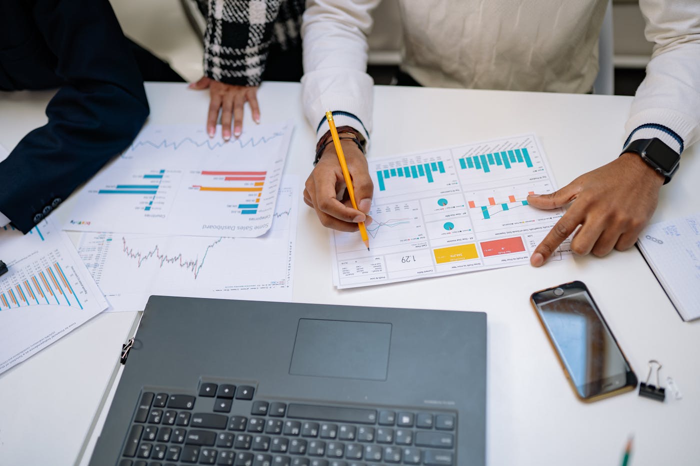 Close-up of spend visibility reports and category breakdown charts on a desk